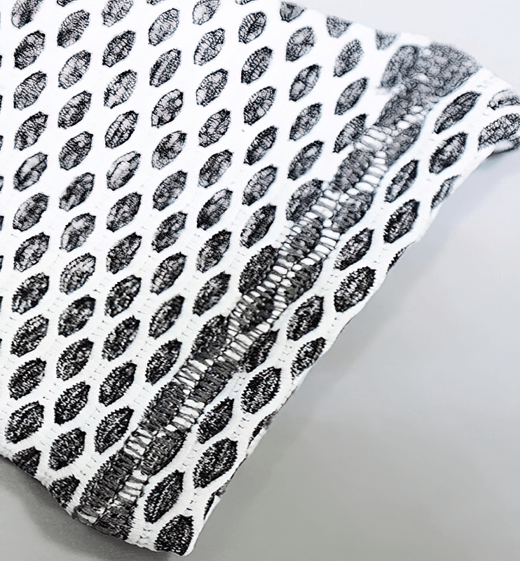 Close-up of high-quality elastic polyester patchwork print on women's seamless tight-cropped shorts, showcasing intricate seam pattern.